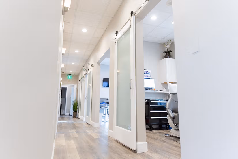 Bright hallway with sliding barn doors inside the practice.